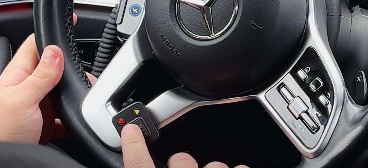 Taxichaufför använder push to talk-knapp i bilen för att prata med ledningscentralen